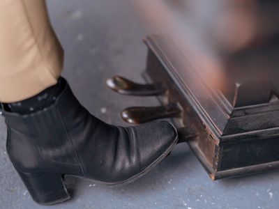Close-up of running shoes on a wooden floor.